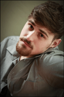 Studio headshot of a man with natural window light. 