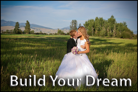 Groom kissing the bride in a field surrounded by beautiful mountains. Build Your Dream Button